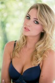Blonde teen Zoey Taylor uncovers her natural tits as she removes her lingerie