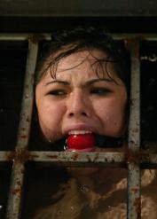 Bound & ball-gagged Asian slave LieLani engaging in water bondage action