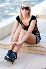 Natural blonde Brittany Lynn uncovers her teensie tits and twat on a sidewalk