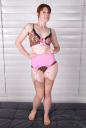 Older redhead babe Lily Cade strutting in lingerie, stockings and garters
