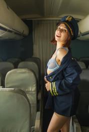 Pretty flight attendant Thea Lun spreads her shaved pussy in a sexy striptease
