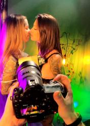 Tattooed chick Tiger Lilly engages in a lesbian sex with a girl on a sofa