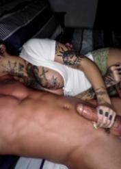 Tattooed girl Genevieve Sinn sucks cum from a finger after giving a blowjob